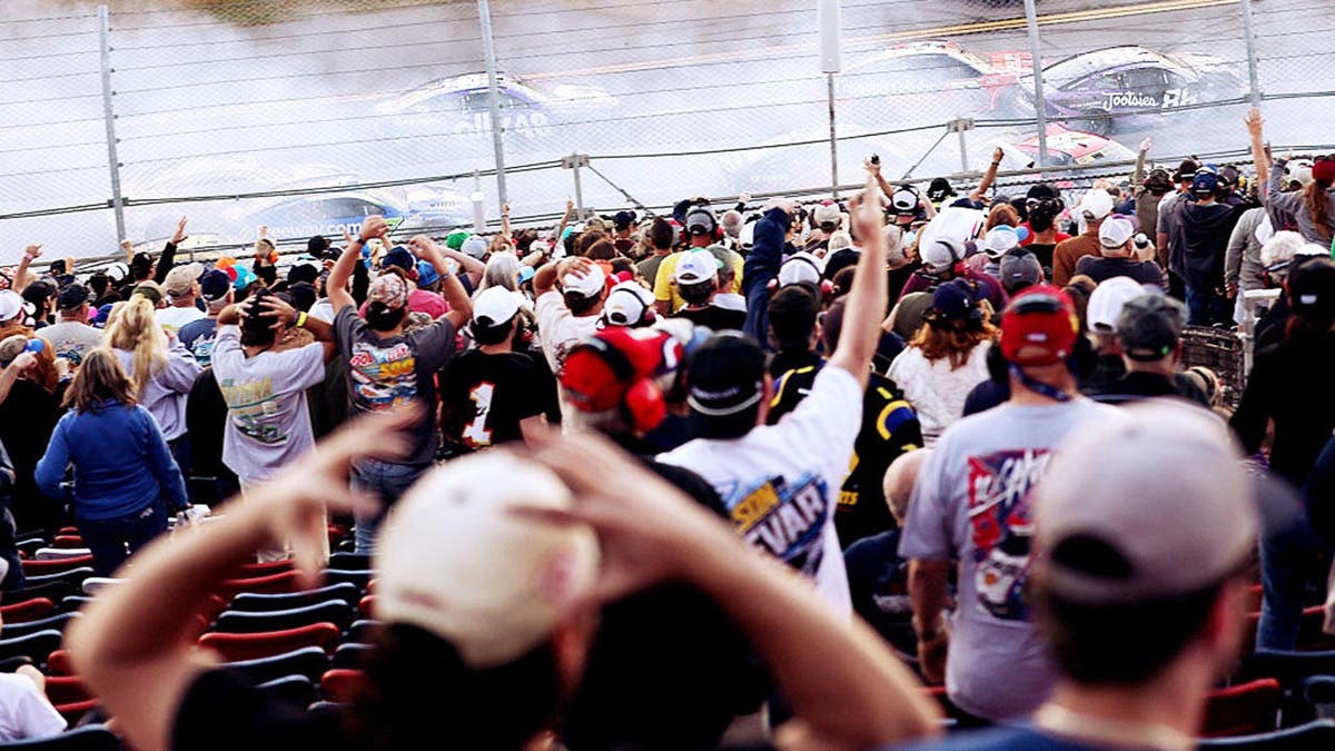 Fans react as an on-track incident occurs at Talladega Superspeedway.