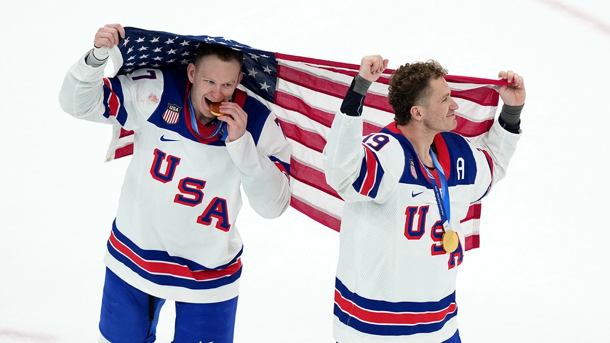 Brady and Matthew Tkachuk hold the flag