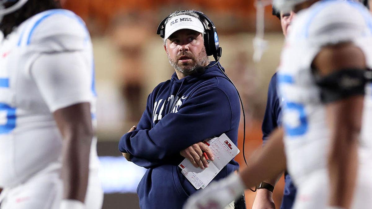 Pete Golding reacts on the sideline during a football game.