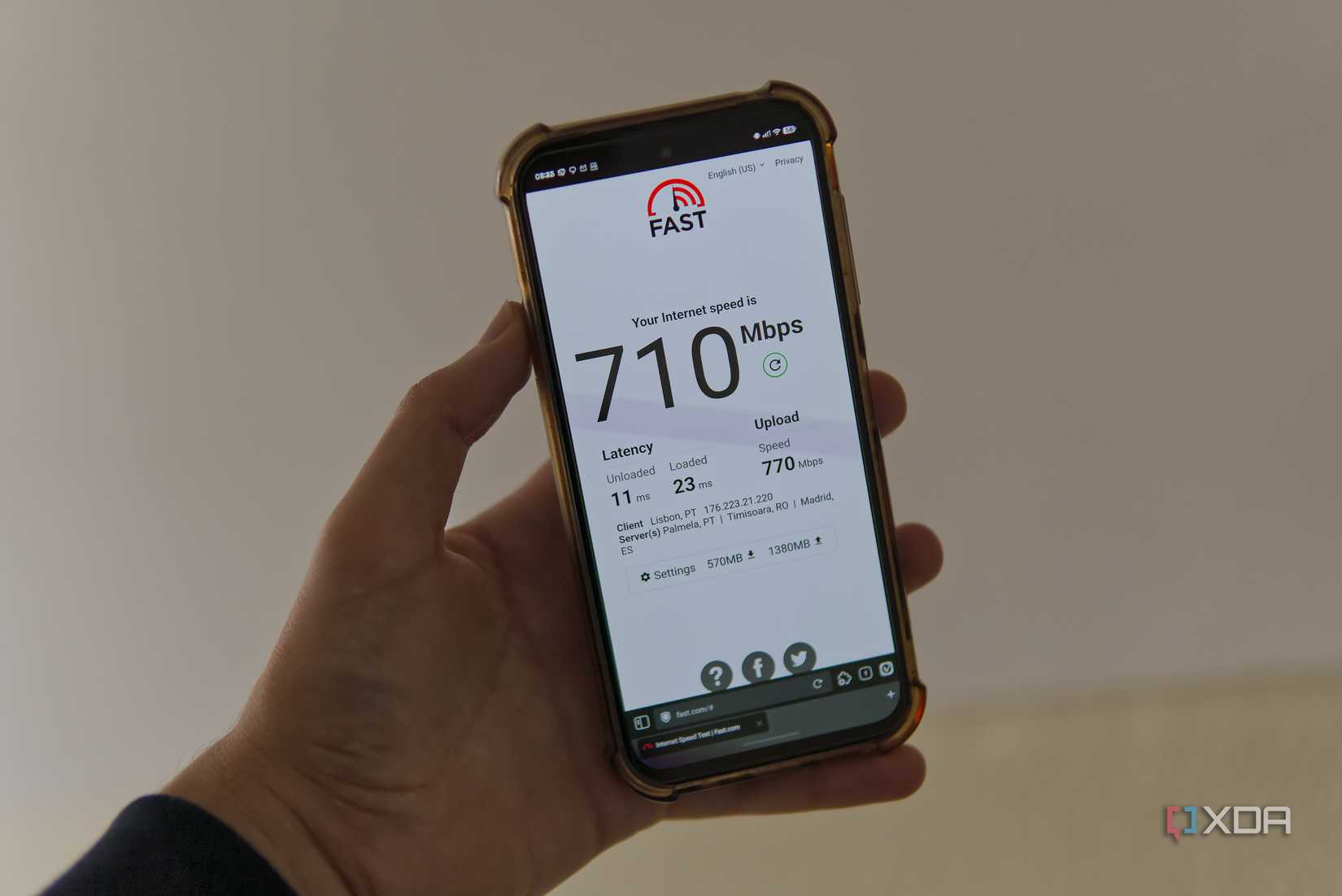 A smartphone showing the results of a speed test on Fast.com