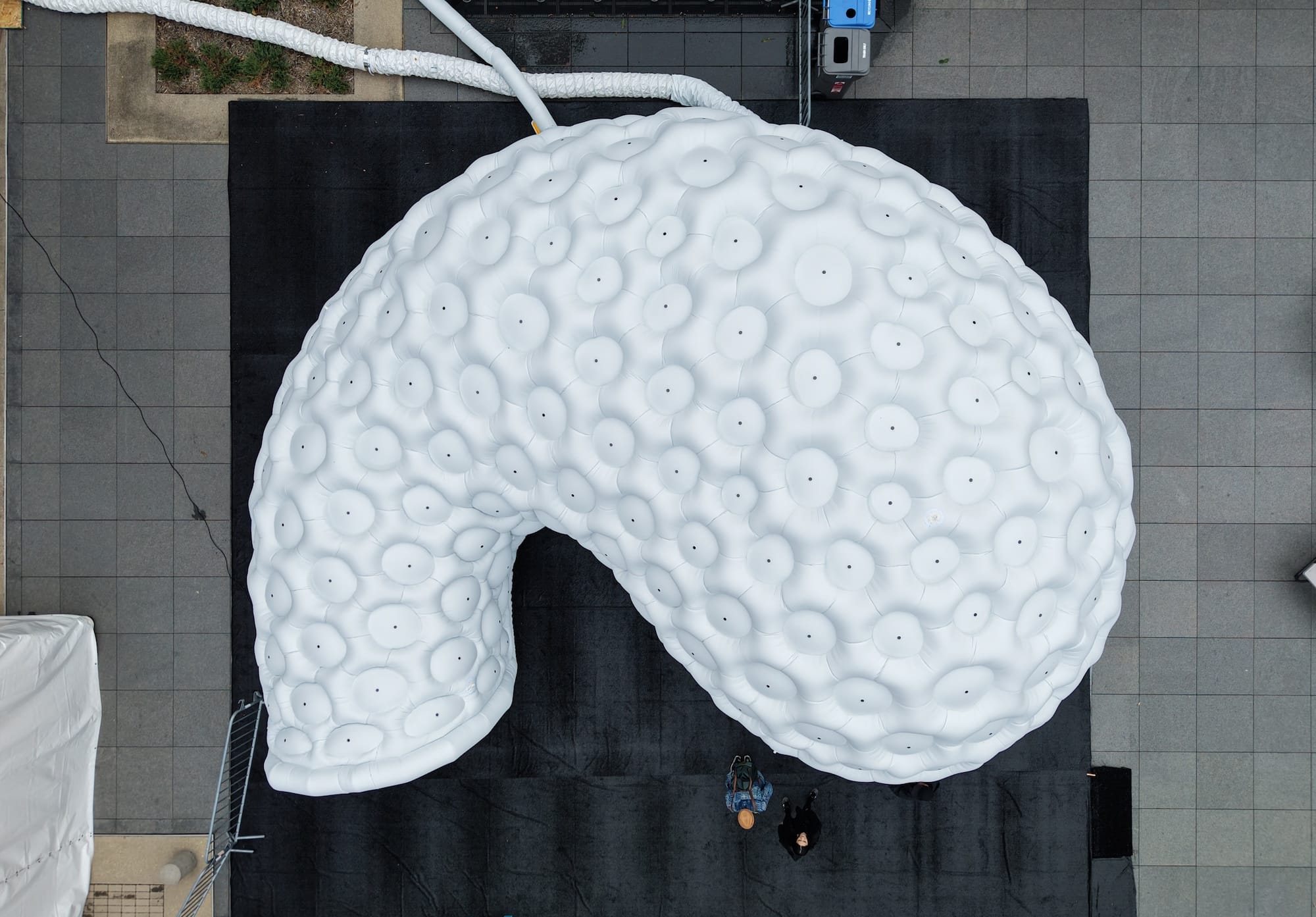 the exterior of an architectural, inflatable compound camera installation, viewed from above via drone