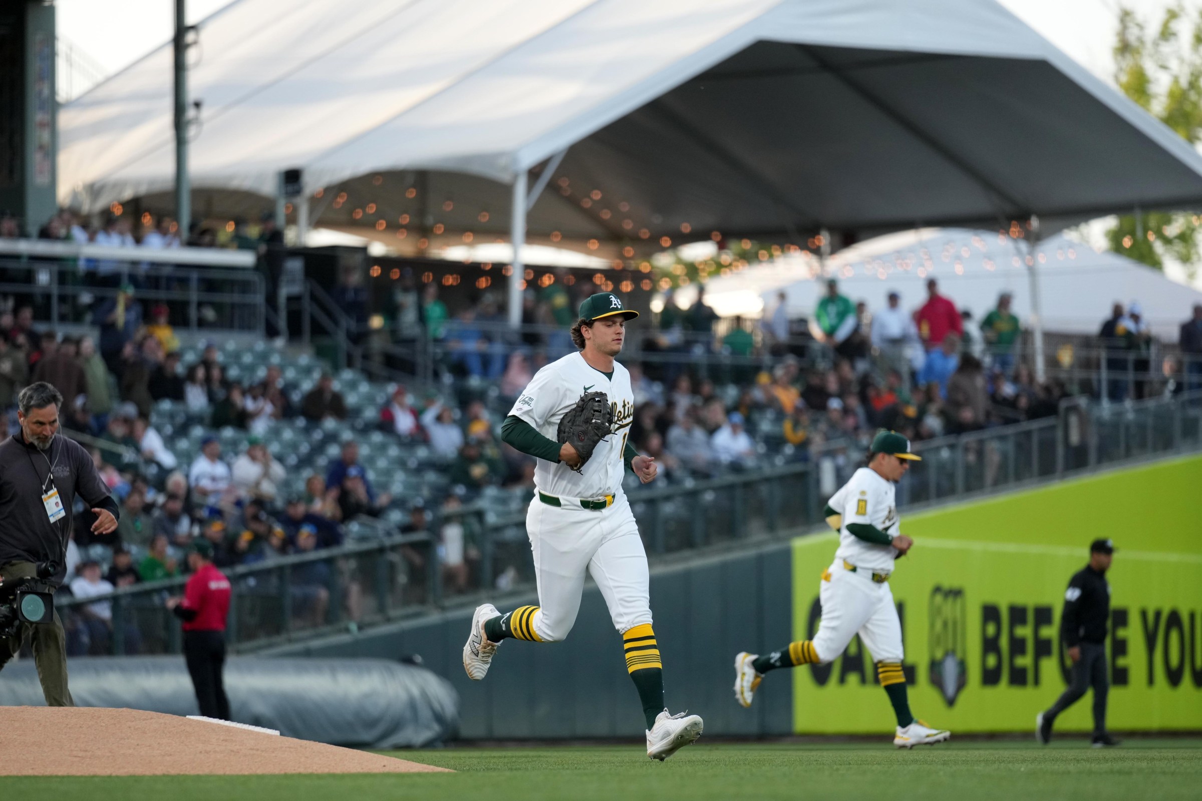 Apr 23, 2025; West Sacramento, California, USA; Athletics first baseman Nick Kurtz (16) jogs onto the field before the start of the game against the Texas Rangers at Sutter Health Park. Mandatory Credit: Cary Edmondson-Imagn Images