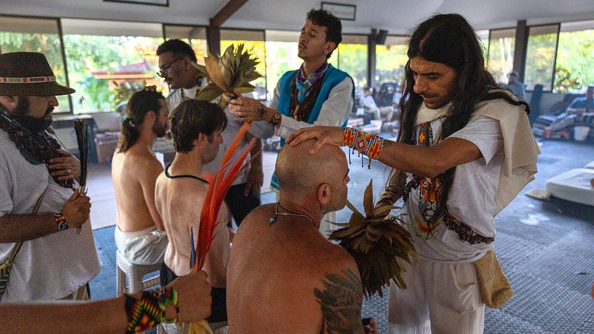 Shamans bless U.S. military veterans at sunrise following an Ayahuasca ceremony in Guanacaste Province, Costa Rica.