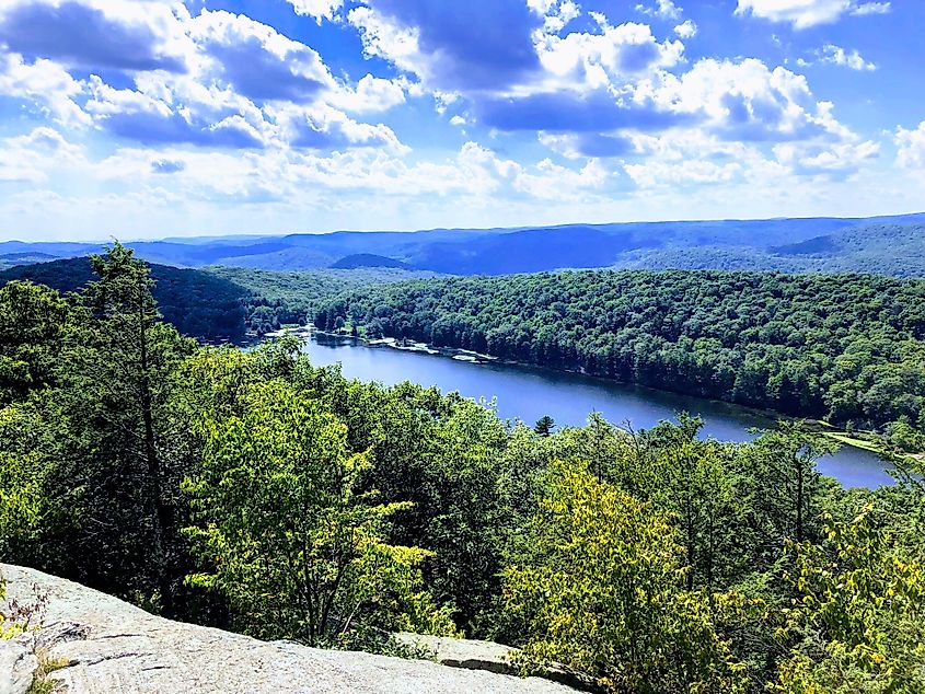 Exposed bedrock above a lake and wooded uplands in Harriman State Park, New York.