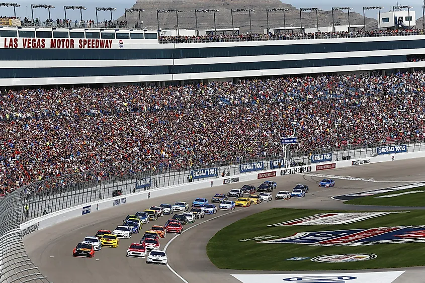 A NASCAR field in front of the grandstands at Las Vegas Motor Speedway