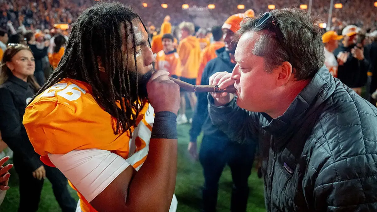 JJ Finch of Tennessee Volunteers lights a cigar after defeating Alabama at Neyland Stadium.