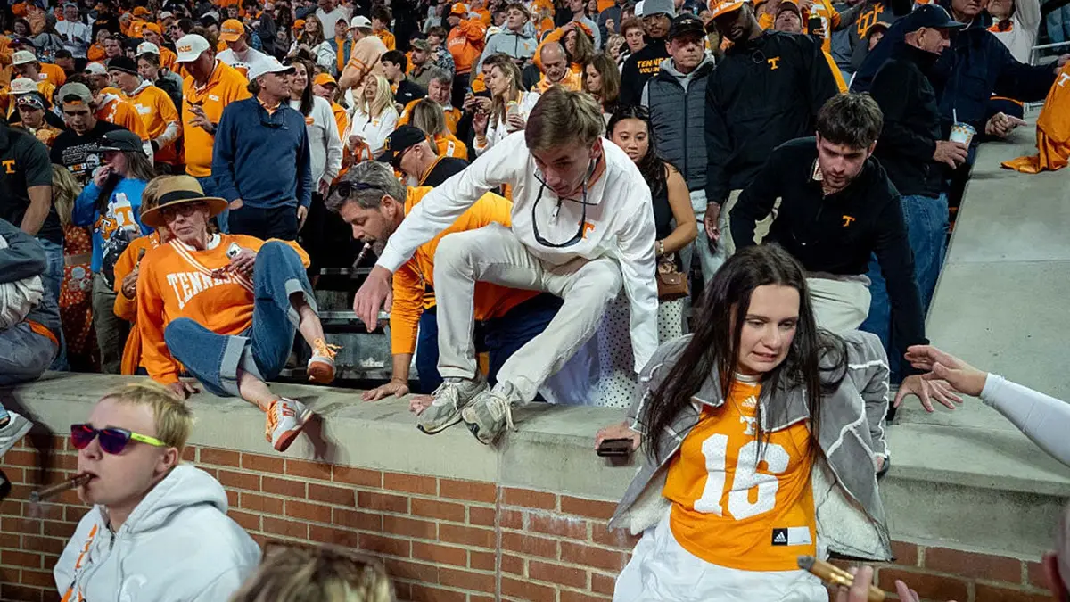 Fans rush onto the field at Neyland Stadium after Tennessee defeats Alabama.
