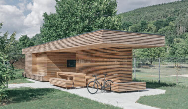 tob.studio’s timber bike station in germany resembles stacked log pile