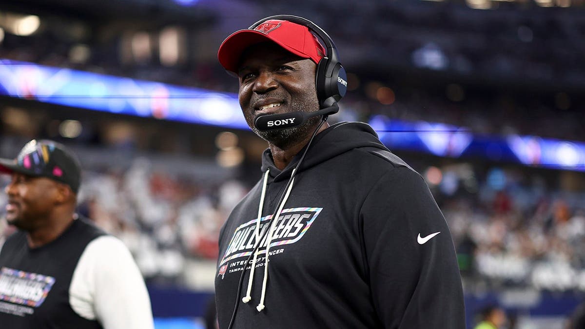 Todd Bowles stands on the sidelines before an NFL game.