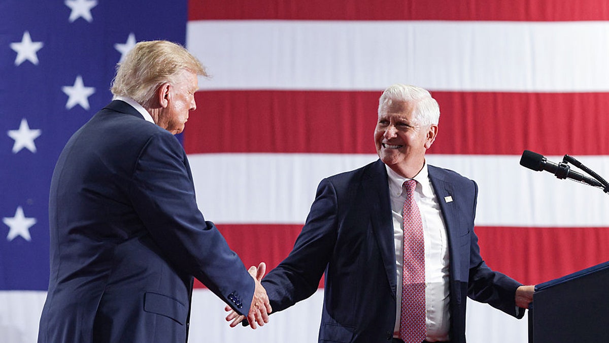 President Donald Trump shakes hands with New York Republican gubernatorial nominee Bruce Blakeman on stage during an election rally at the Oncenter on Oct. 9, 2026 in Syracuse, N.Y.