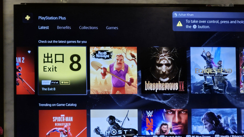 A TV screen that shows benefits of PlayStation Plus subscription with a catalog of games