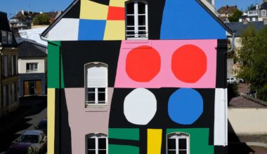 a colorful, geometric abstract mural on an urban wall