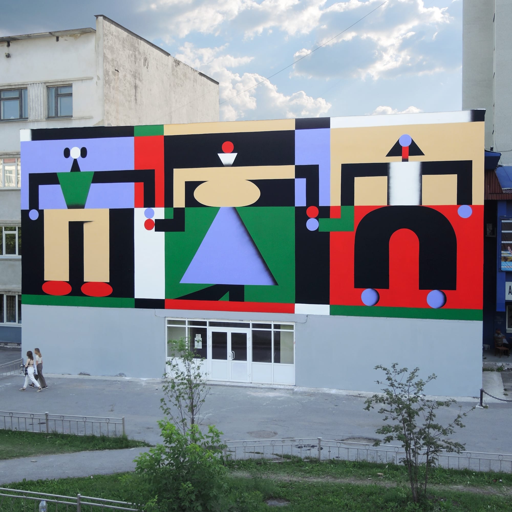 a colorful, geometric abstract mural on an urban wall