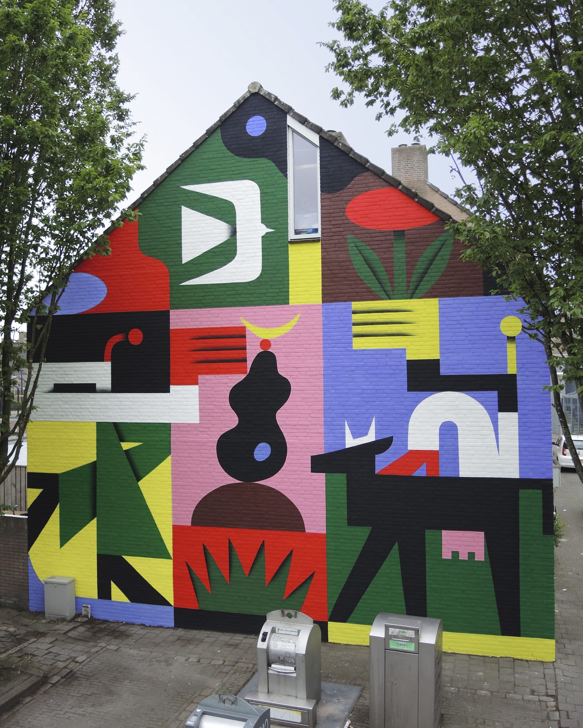 a colorful, geometric abstract mural on an urban wall