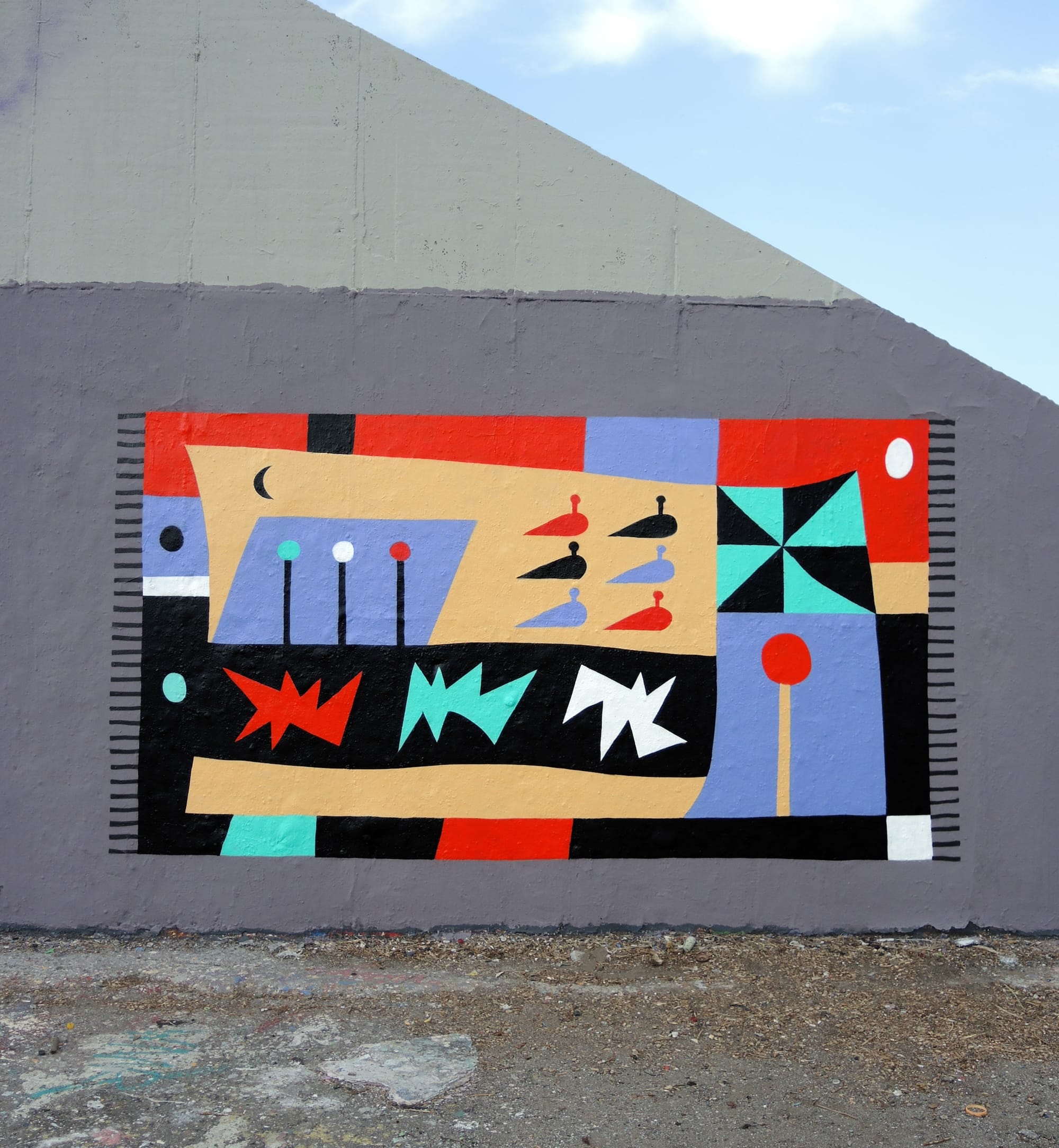 a colorful, geometric abstract mural on an urban wall