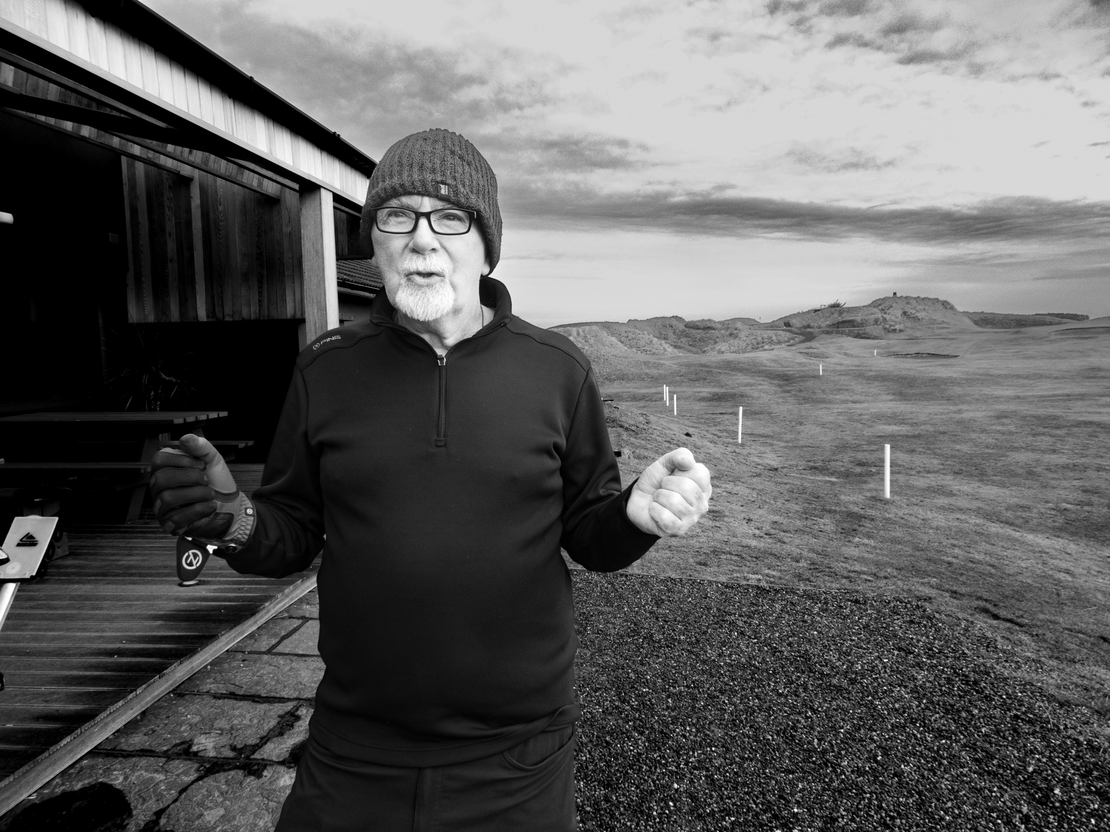 Black and white photo of a man on a golf course.