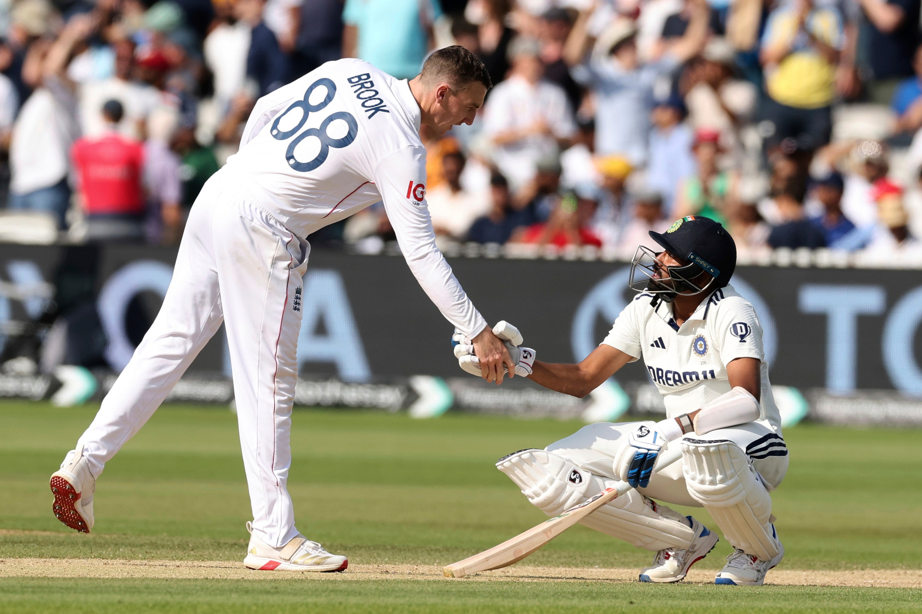 Harry Brook and Mohammed Siraj shaking hands after a cricket match.