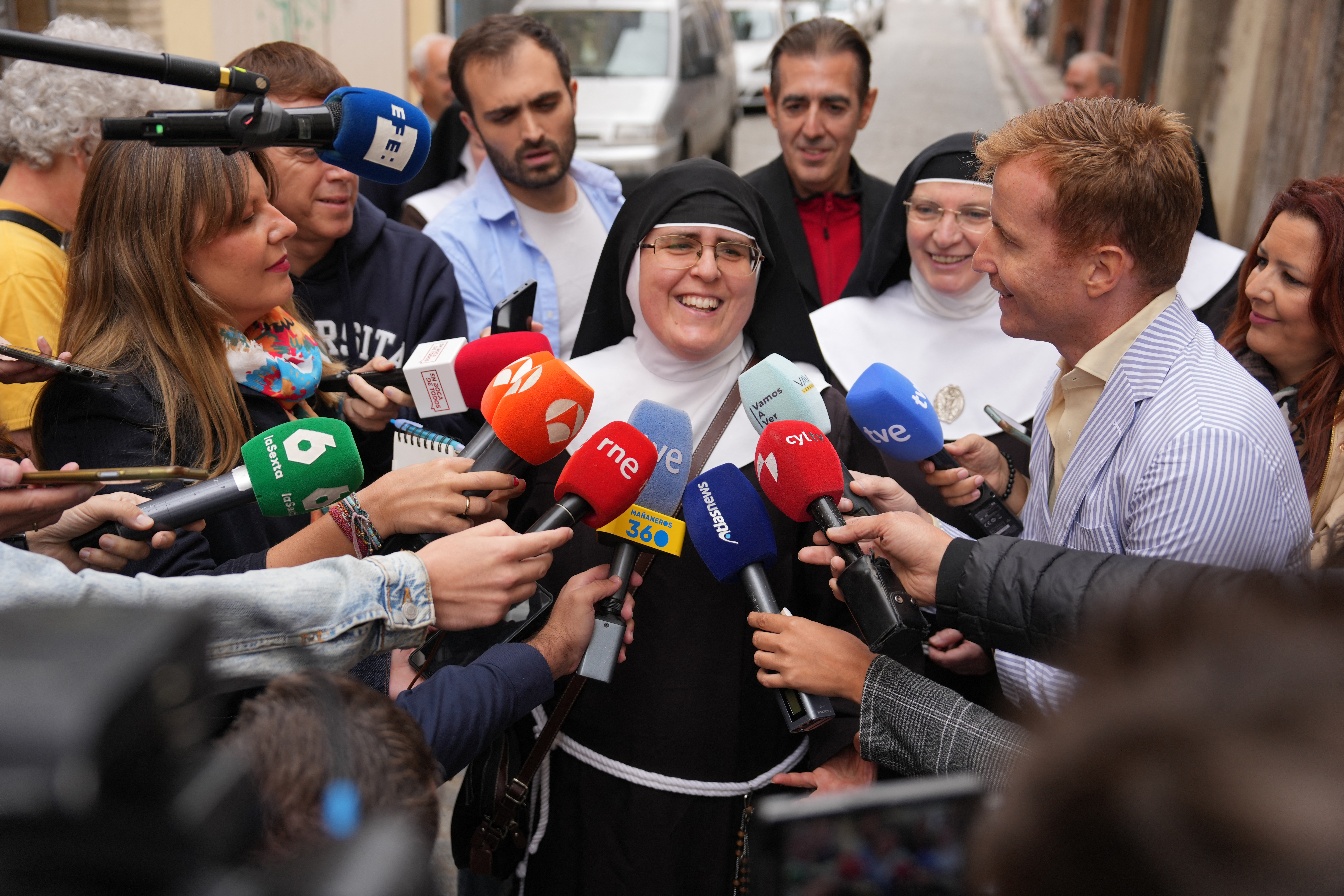 A former nun speaks to reporters outside a courthouse.
