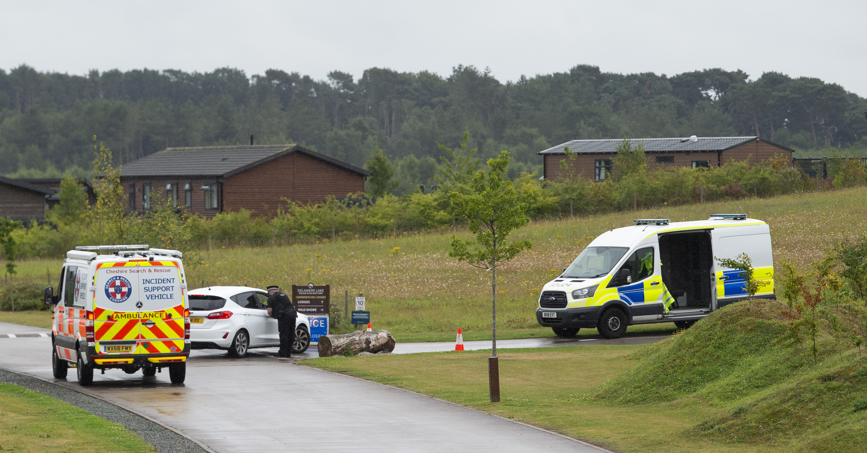 Police and emergency vehicles at a residential area searching for Rachel Booth.