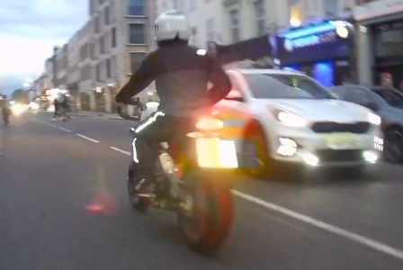 Motorcycle driving on a city street.