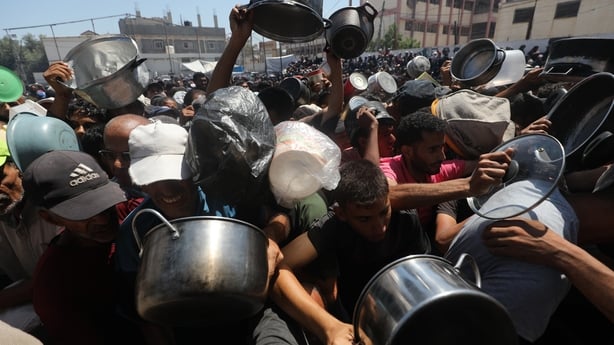 People in Gaza are crushed together as they queue to receive food distributed by a charity organisation in Gaza City on July 19, 2025