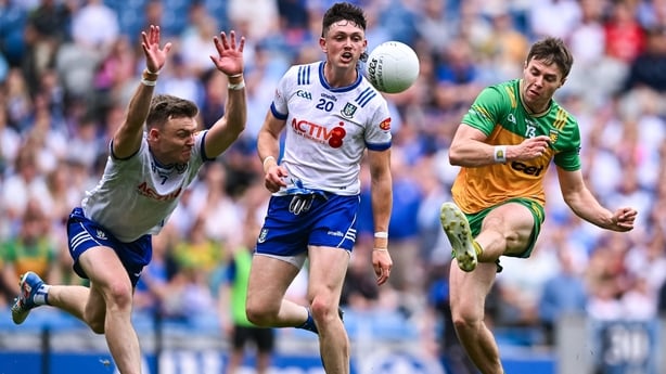 28 June 2025; Conor O'Donnell of Donegal scores a point under pressure from Conor McCarthy, left, Gary Mohan of Monaghan during the GAA Football All-Ireland Senior Championship quarter-final match between Monaghan and Donegal at Croke Park in Dublin. Photo by Piaras Ó Mídheach/Sportsfile