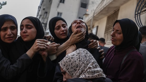 Palestinians mourn for their relatives those who were killed in Israeli airstrike in al Shati Camp in Gaza Strip