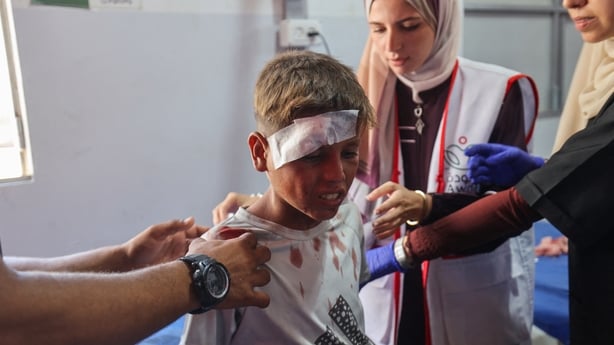 A child receives treatment at Al-Awda hospital in Gaza after an Israeli strike on an apartment at the Nuseirat refugee camp