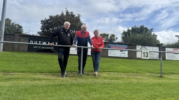 The parents of Kerry footballers from Daingean Uí Chúis watch from the sidelines of a gaelic pitch.