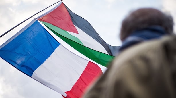 The French flag and the Palestinian flag at a rally for Palestine in Paris, France