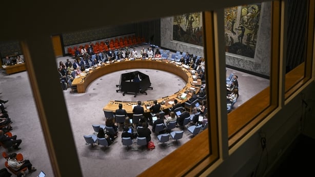 a group of people sitting around a round table