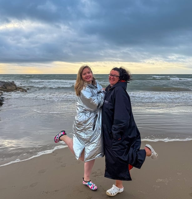 a person and person standing on a beach
