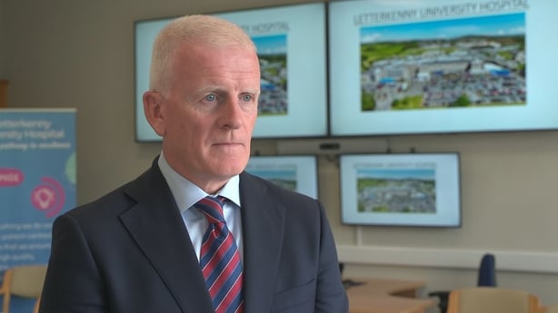 An image of Tony Canavan speaking to press