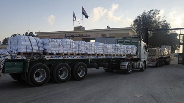 A lorry loaded with pallets of humanitarian aid waits to cross into Gaza at Rafah