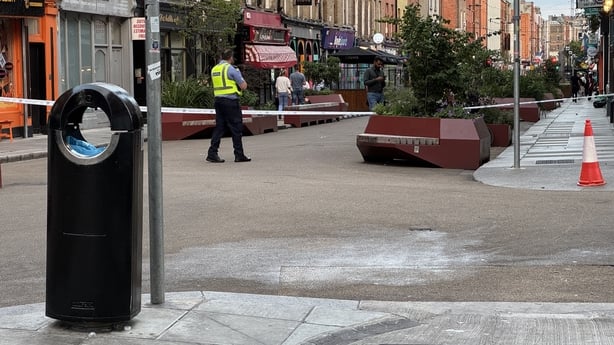 A view of Capel Street in Dublin with a garda in the background 