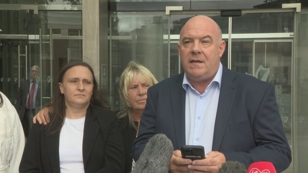 CEO of Sonas David Hall stands with Natalie Ennis speaking on her behalf to the press