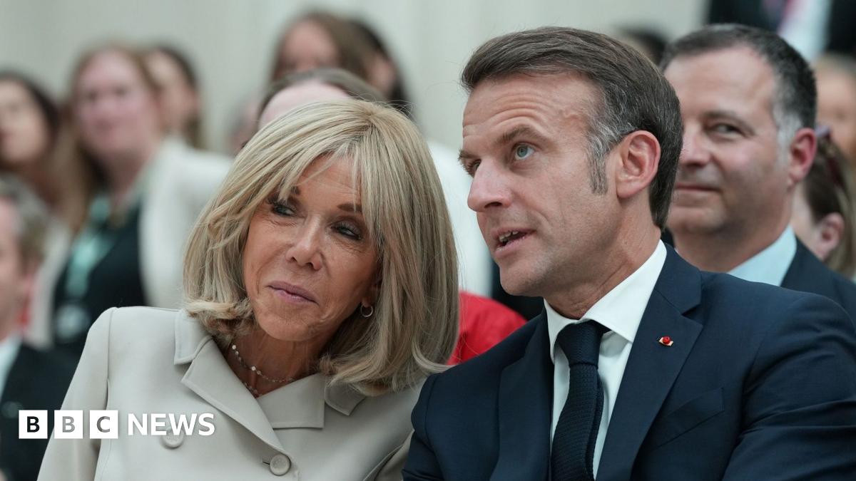Brigitte and Emmanuel Macron pictured at a public event in London earlier this month, seated and leaning towards each other