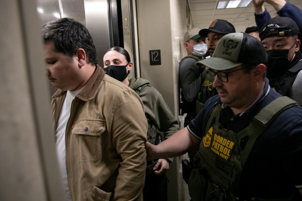 Federal agents bring a couple onto an elevator at 26 Federal Plaza after they finished an immigration hearing.