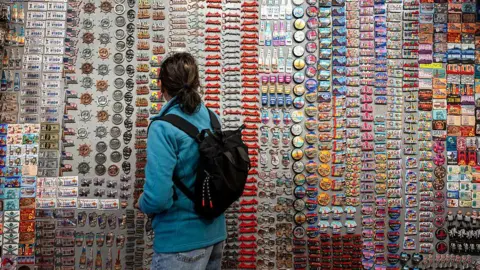 Bloomberg/Getty A shopper looks at magnets at a gift store in the Chinatown neighborhood of San Francisco, California, US, on Wednesday, June 25, 2025.