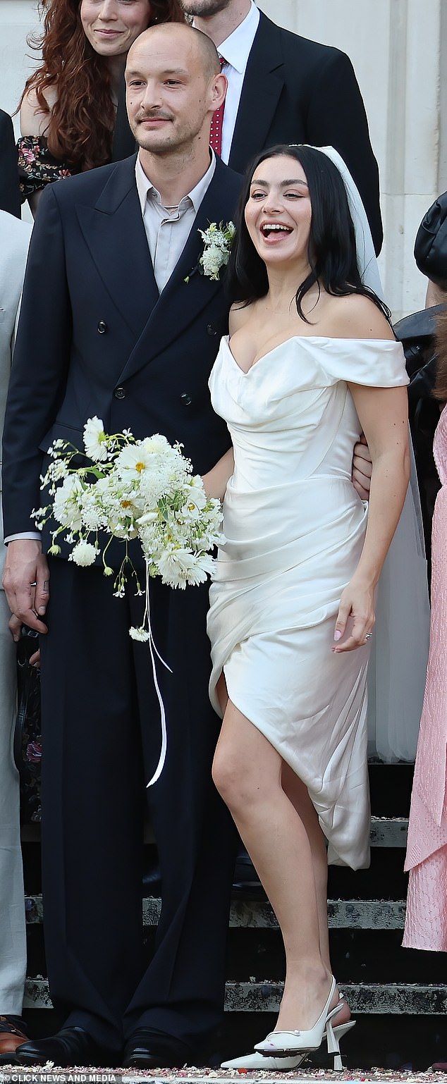 Slipping her feet into Jimmy Choo heels, she wore her long raven tresses loose and carried a bouquet of white flowers