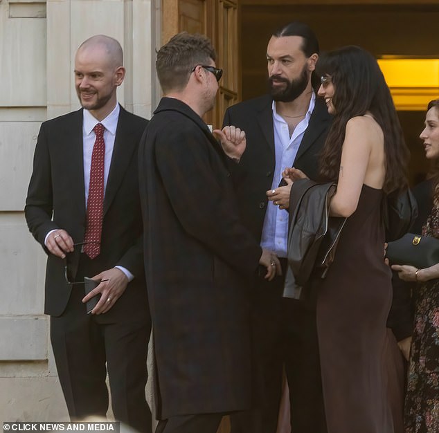 The couple's nearest and dearest were in attendance including The 1975 bandmates Adam Han (L) and Ross MacDonald (far right)