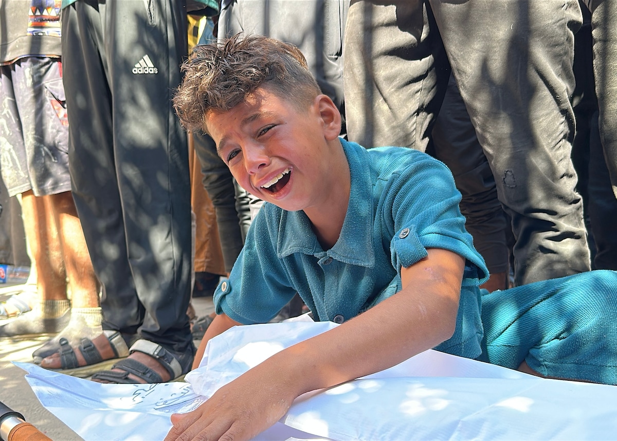 A Palestinian child mourns a loved one killed on Wednesday while seeking aid in Khan Younis, at Nasser hospital in the southern Gaza Strip on July 16, 2025. (Photo: Moaz Abu Taha/APA Images)
