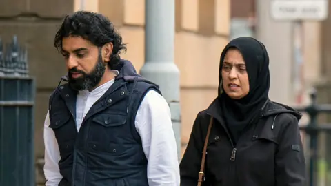 PA Media Omer and Attiya Sheikh walking into court ahead of sentencing