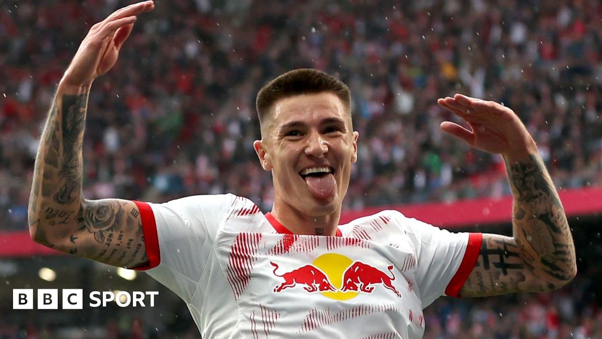 Benjamin Sesko raises his arms in celebration after scoring for RB Leipzig