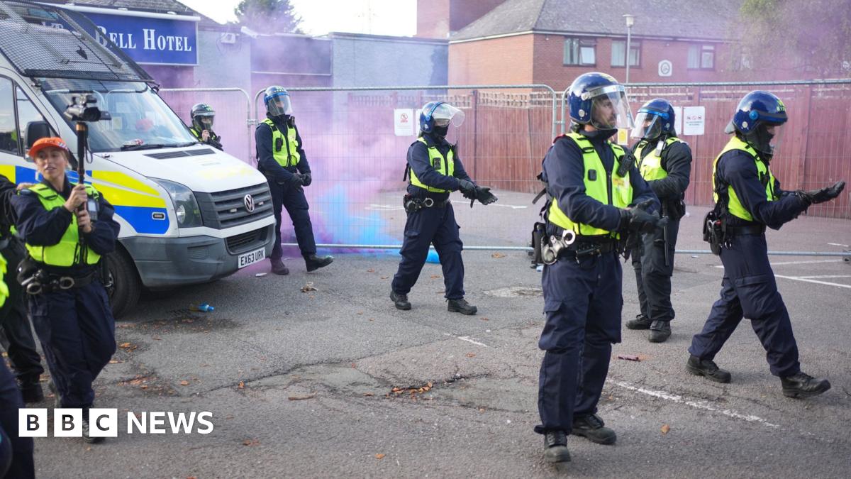 crowd of people - some wearing masks - gathering
