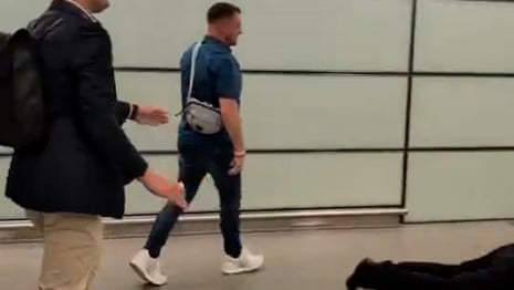 Tommy Robinson filmed near injured man at London train station – video