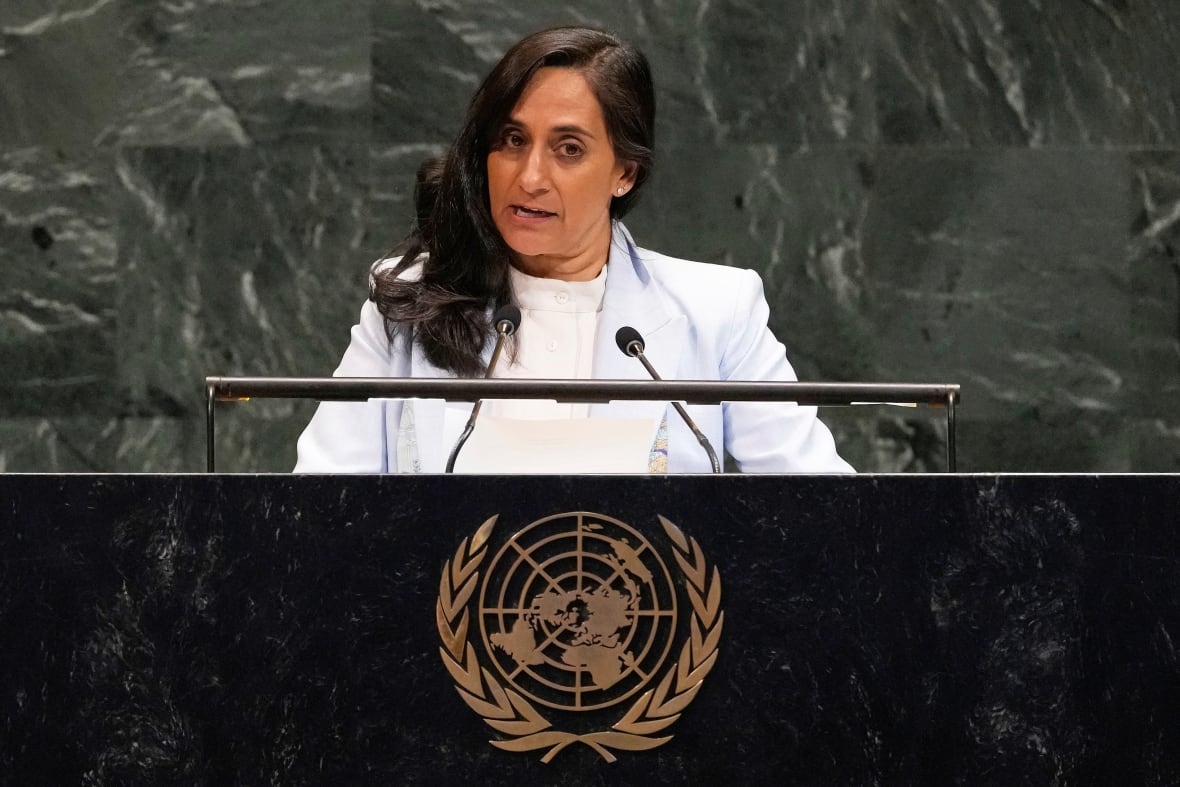 A woman speaks at a podium.