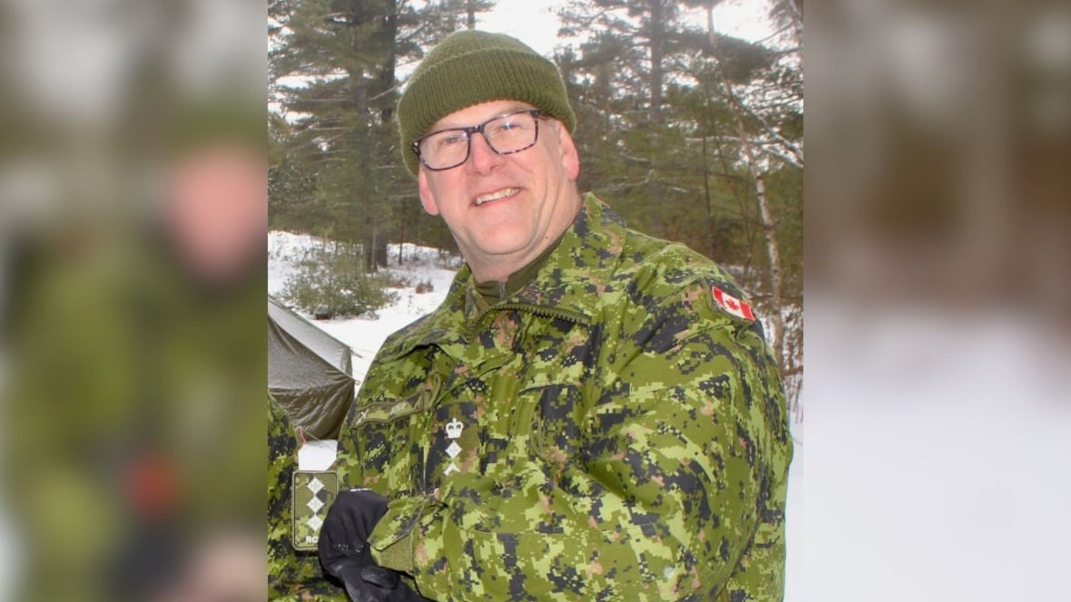 A man in army fatigues in winter.