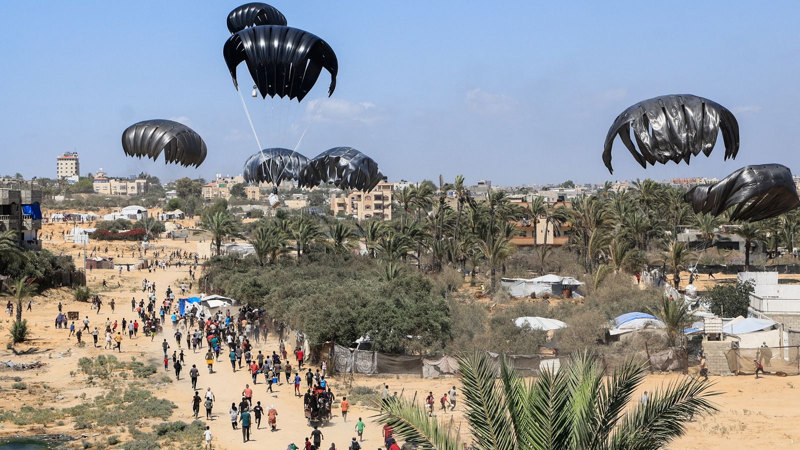 Aid packages descend over Gaza. Pic: Reuters