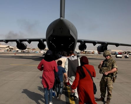People boarding a hangar plane at Kabul airport